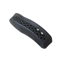 A black textured rubber or butt pad with a honeycomb pattern and molded finger grooves, shown on a transparent background.