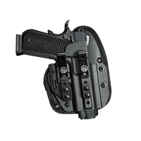 A black tactical holster shown with a handgun inserted, photographed on a transparent background. The holster has a textured finish, a belt clip, and visible logo markings.