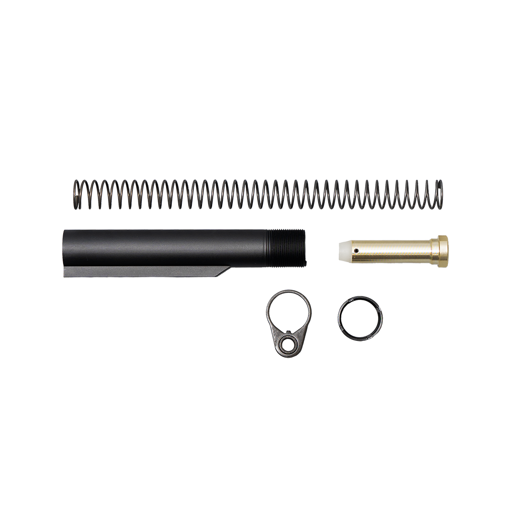Top-down flat-lay product shot of a complete rifle buffer tube assembly kit including a black aluminum buffer tube, recoil spring, brass-toned buffer weight, end plate, and castle nut, isolated on a transparent background.