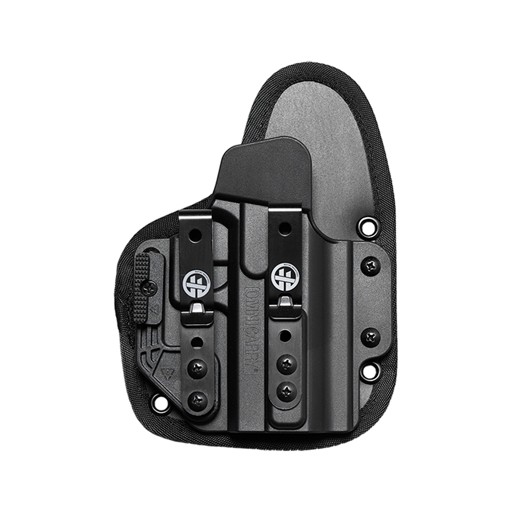 A black tactical holster with a quick-release clip and a gray insert panel, shown from a top-down view on a transparent background.