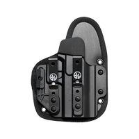 A black tactical holster with a quick-release clip and a gray insert panel, shown from a top-down view on a transparent background.