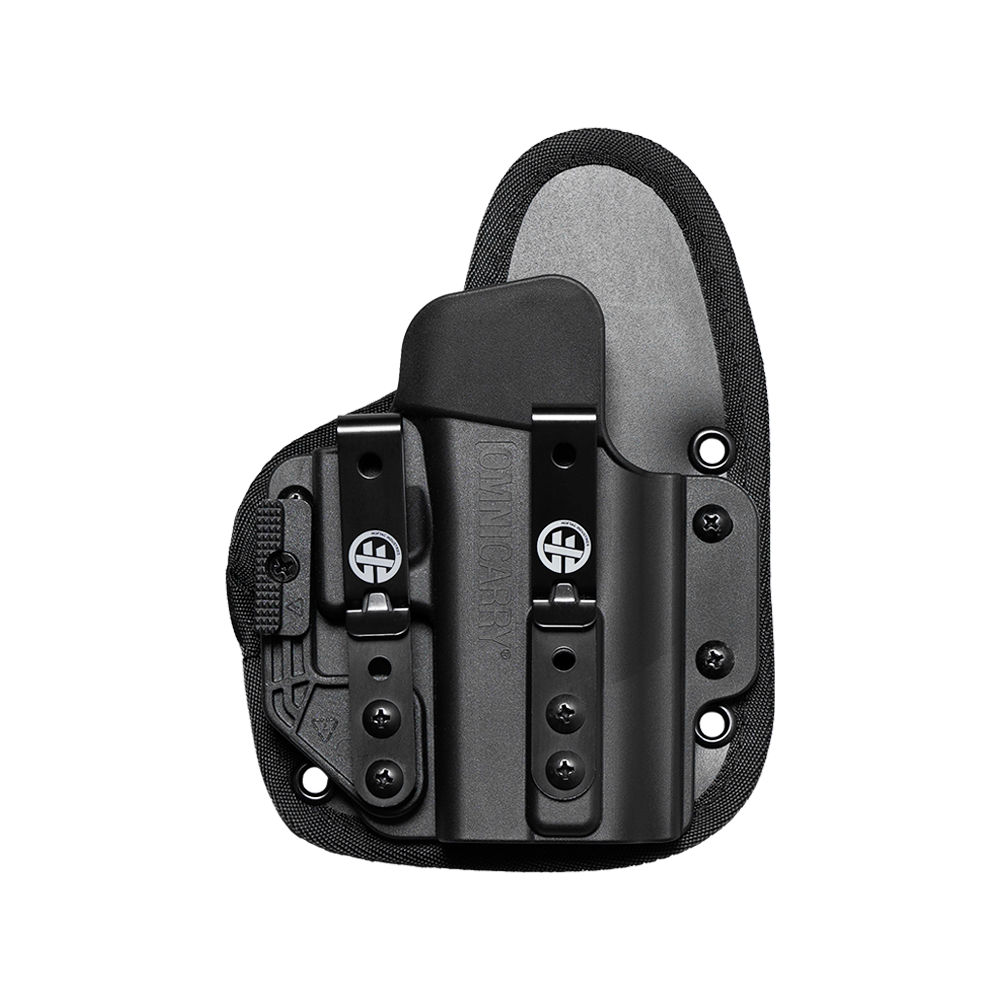 A black tactical holster with a black polymer insert and a gray fabric backing, shown on a transparent background. The holster features a quick-release buckle with a circular logo emblem.