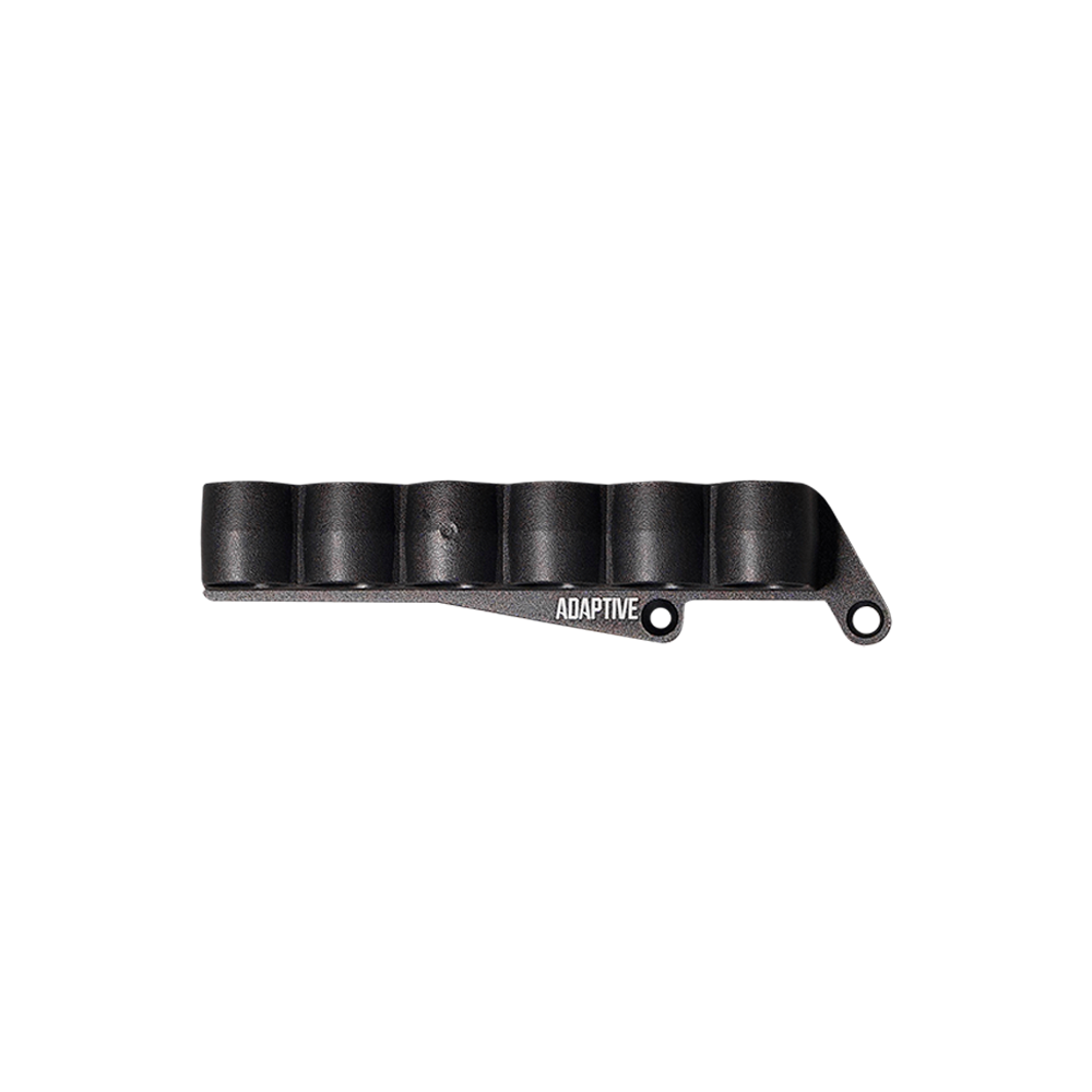 A black polymer 6-shell shotgun side saddle shell carrier with Adaptive branding and receiver mounting screw holes, isolated on a transparent background.