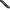 Close-up of a black textured firearm stock or handle attachment with a red accent visible at the far left, shown against a transparent background.