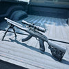 Rifle with scope on a truck bed