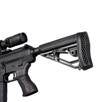 A close-up studio shot of a black tactical rifle with an attached scope, showing the receiver, pistol grip, and a black adjustable buttstock with a honeycomb-patterned vent on the rear, set against a transparent background.