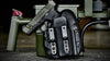 Handgun in a holster on a table with a green box in the background